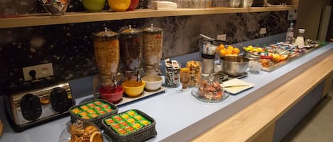 A buffet with various food items and condiments.