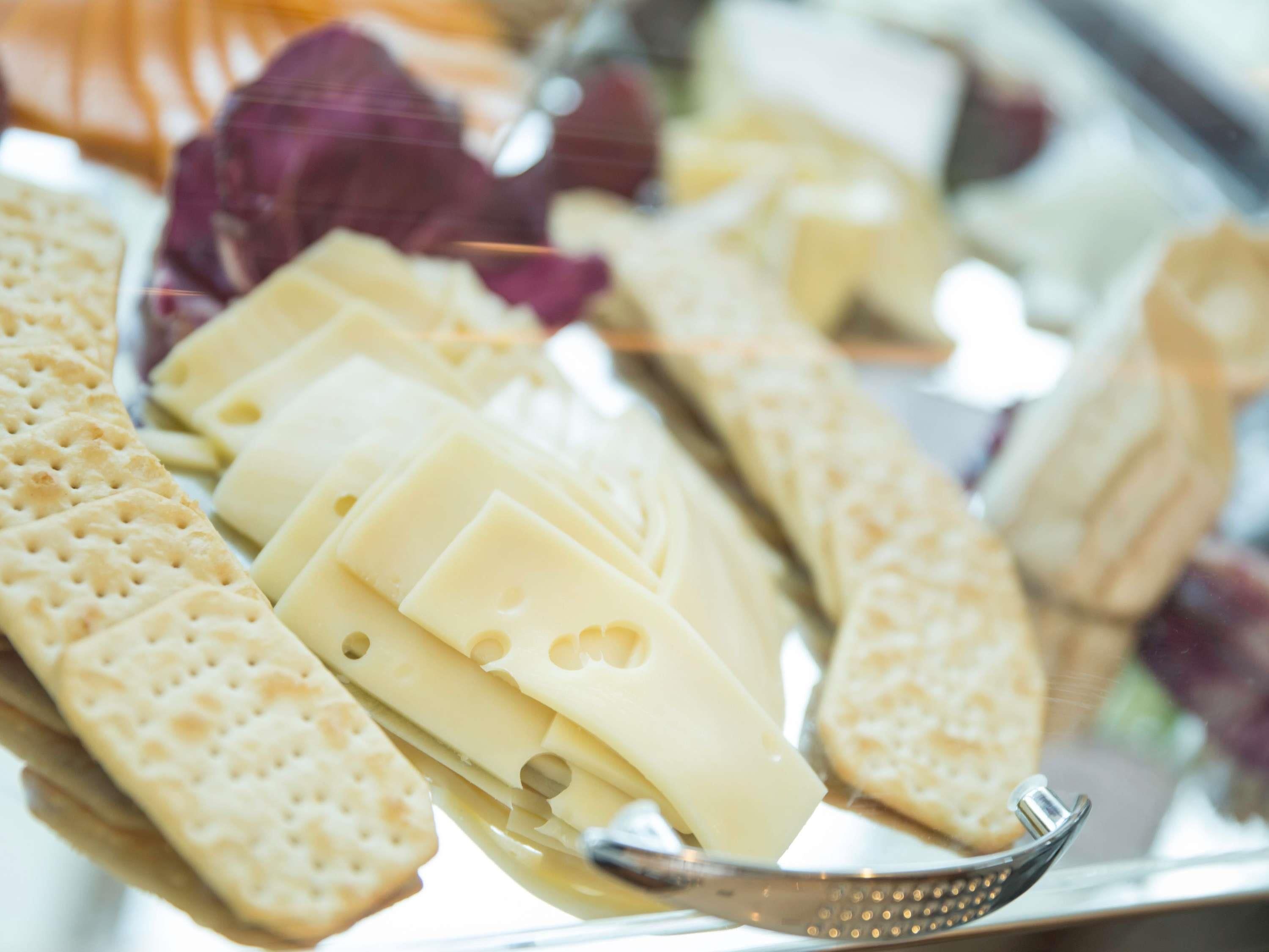 A cheese platter with crackers and a cheese knife.