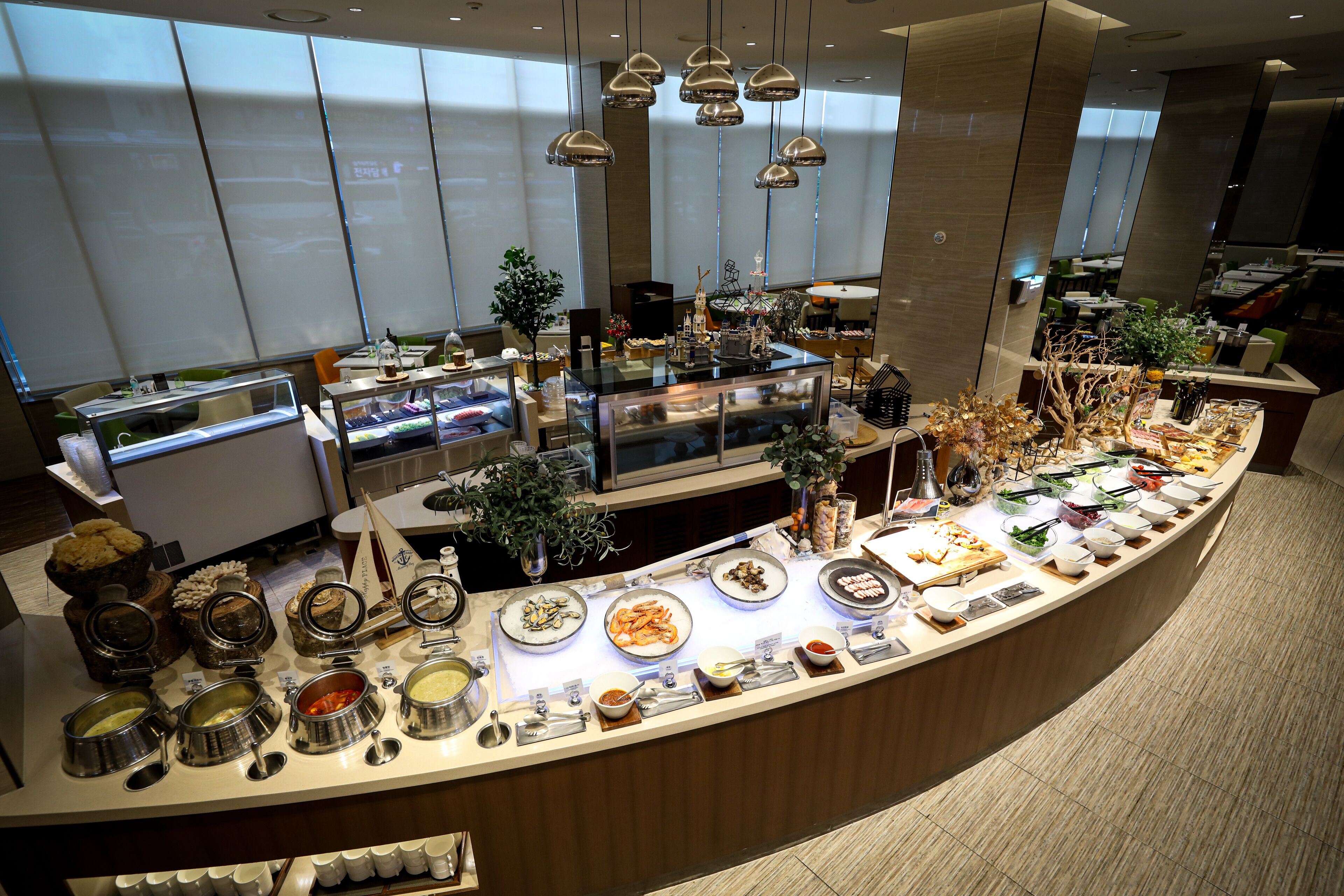 A buffet with various food items and condiments.