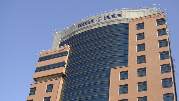 A tall hotel building with a curved glass facade and a sign reading "Paragon Hotel". - Paragon Hotel Apartments (Abu Dhabi)