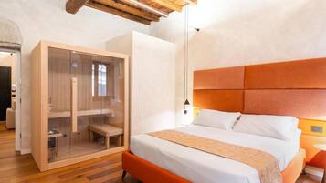 A modern bedroom with a wooden ceiling, a large bed with an orange headboard, and a glass-fronted wardrobe.