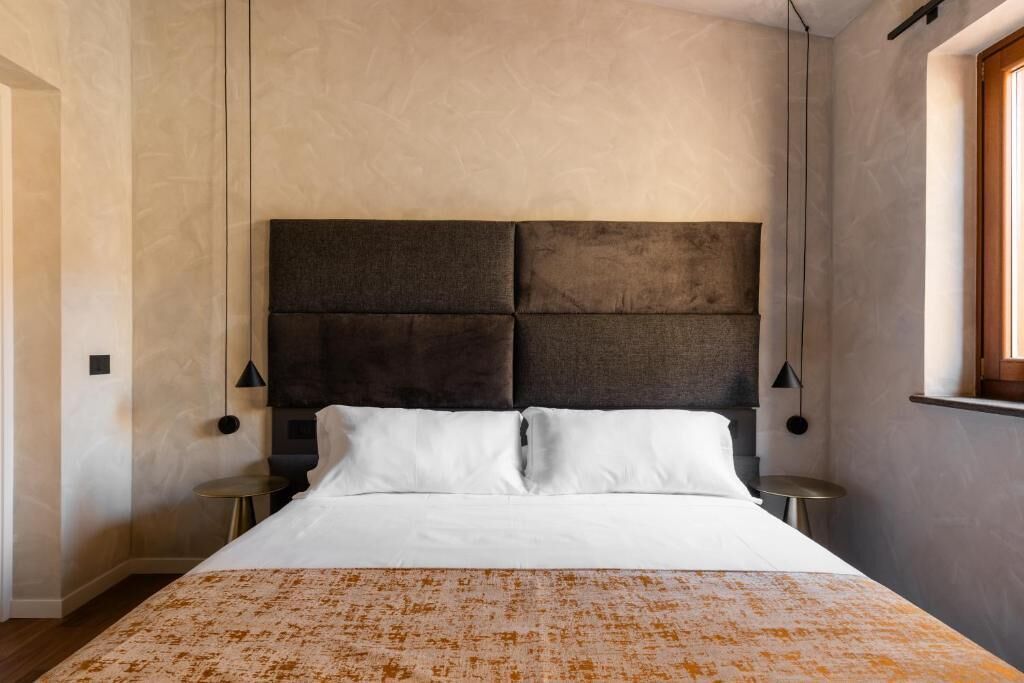 Una camera da letto con un letto grande, due comodini e una finestra.
