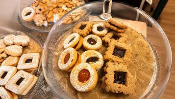 A glass display case with various cookies and pastries.