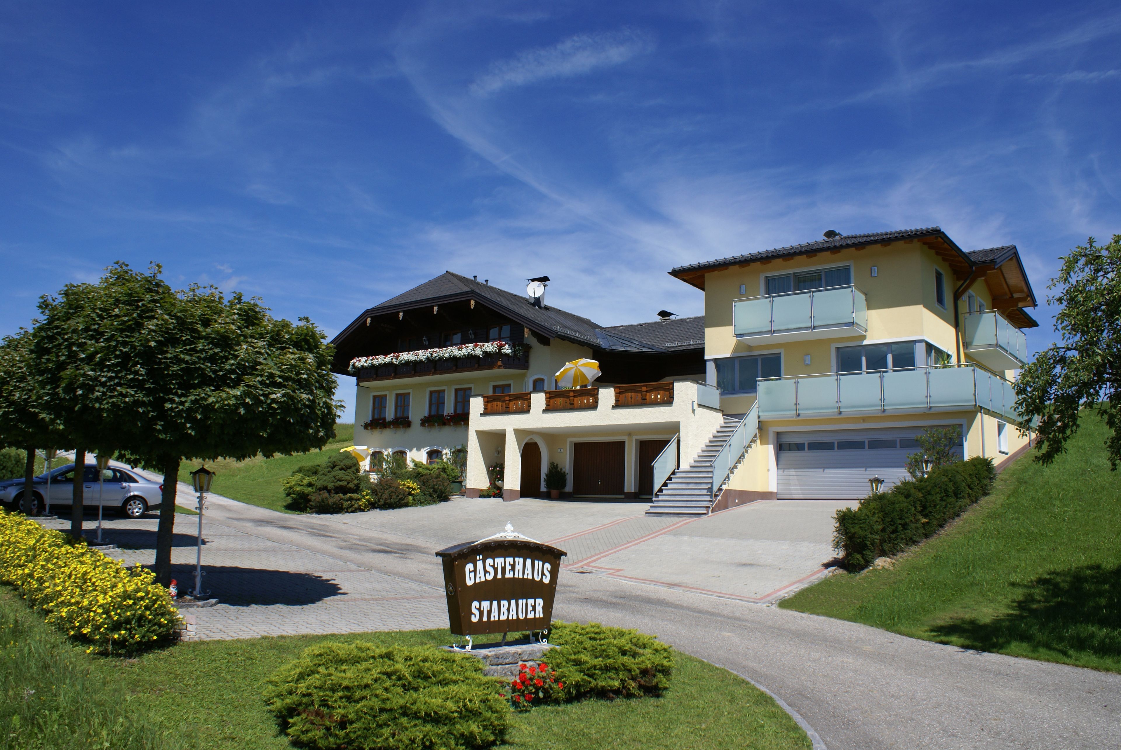 A two-story building with a sign reading "Gästehaus Stabauer".