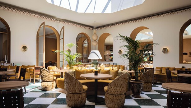 A spacious lobby with high ceilings, large arched windows, and a checkered floor. - Hôtel Maison Chiberta (Anglet)