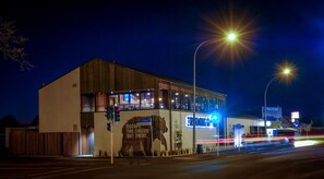 A building with a large mural of an elephant and the text "ESCAPE THE CIRCUS OUT THERE." - Claudelands Motel (Hamilton)