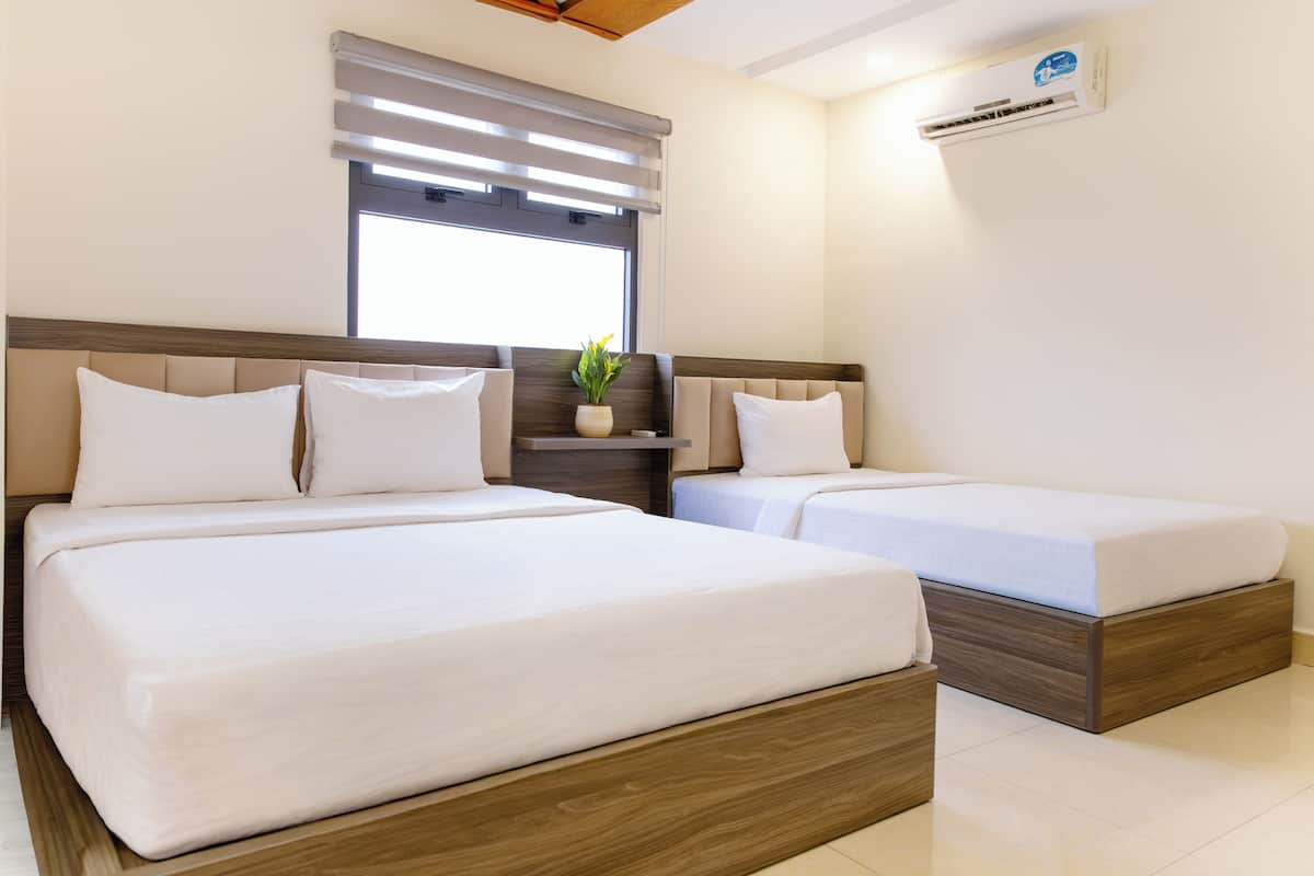 Deluxe Triple Room, City View | Minibar, in-room safe, desk, soundproofing