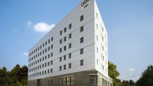 A modern hotel building with a white facade and multiple windows. - OKKO Hotels Grenoble Centre (Grenoble)