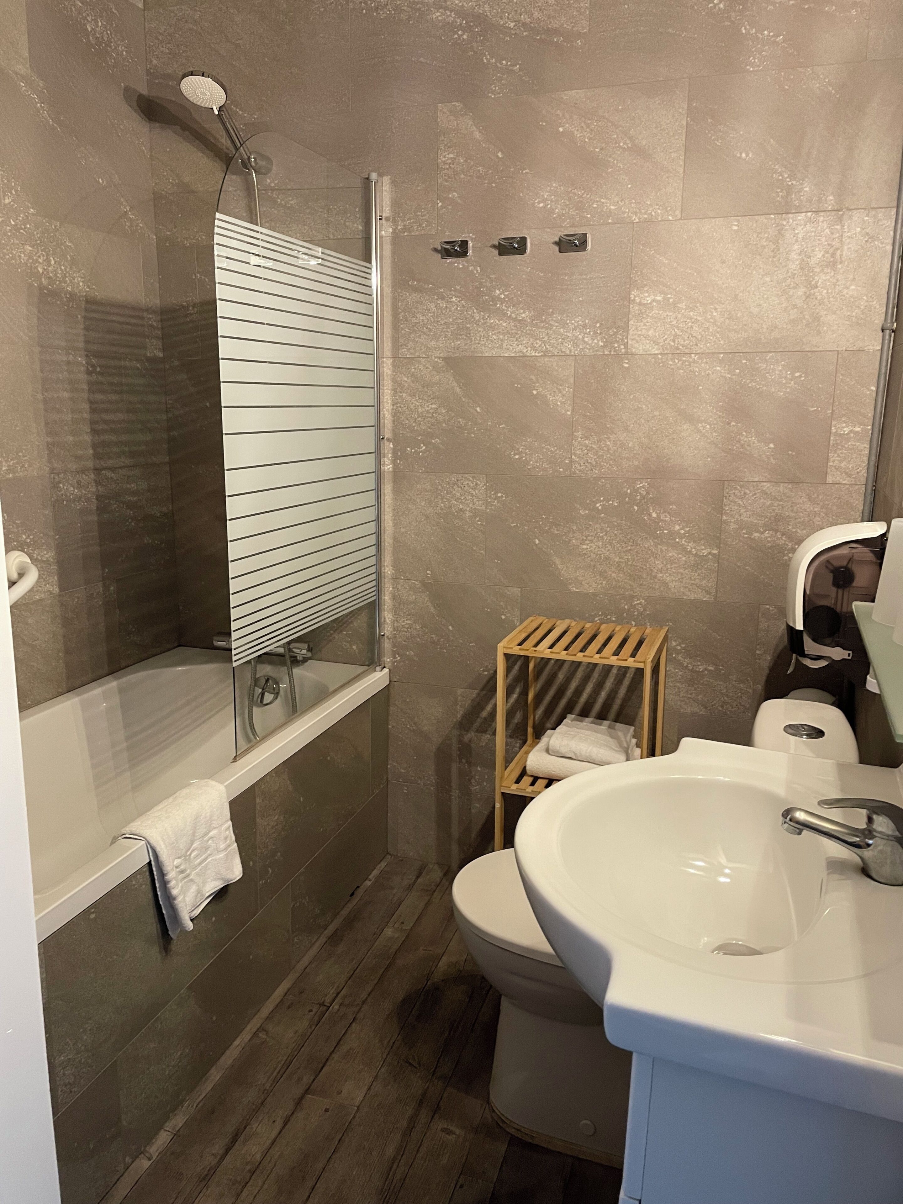 A bathroom with a bathtub, a toilet, a sink, and a shower.