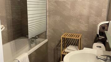 A bathroom with a bathtub, a toilet, a sink, and a shower.