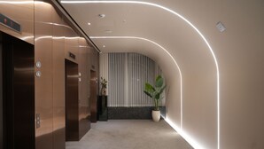 A modern elevator with a metallic finish and a control panel. - Eldis Regent Hotel (Daegu)