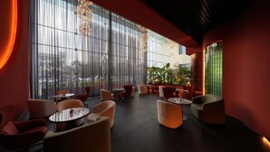 A modern lounge with large windows, comfortable seating, and decorative lighting. - Eldis Regent Hotel (Daegu)