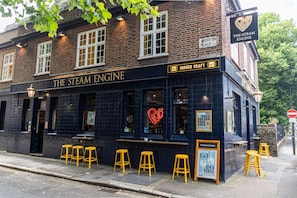 A brick building with a sign reading "The Steam Engine" and "Burger Craft." - PubLove @ The Steam Engine - Hostel (London)