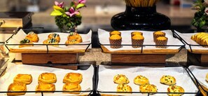 A variety of pastries displayed on trays in a buffet setting. - The Westin Changsha (Changsha)