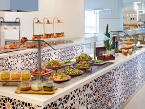 Un buffet proposant divers plats et accompagnements.