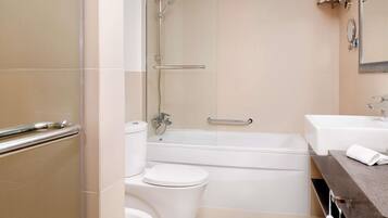 A bathroom with a bathtub, toilet, and sink.