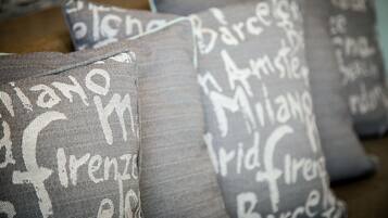 A collection of grey pillows with white text.