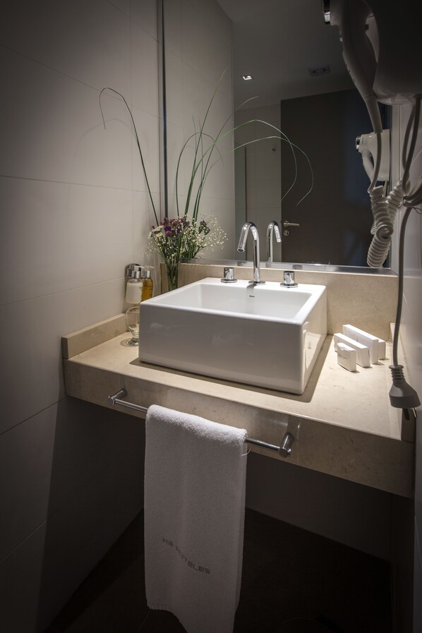 A modern bathroom with a white sink, a towel rack, and a mirror. - Brizo Neuquen (Neuquén)