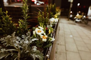 A row of flower planters along a sidewalk at night. - PubLove @ The Crown, Battersea - Hostel (London)