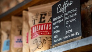 A coffee menu on a chalkboard, listing items like cappuccino, flat white, and iced tea. - PubLove @ The Crown, Battersea - Hostel (London)