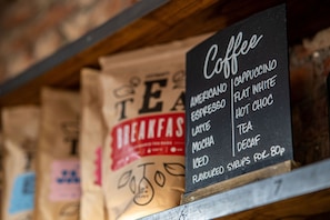A coffee menu on a chalkboard, listing items like cappuccino, flat white, and iced tea. - PubLove @ The Crown, Battersea - Hostel (London)