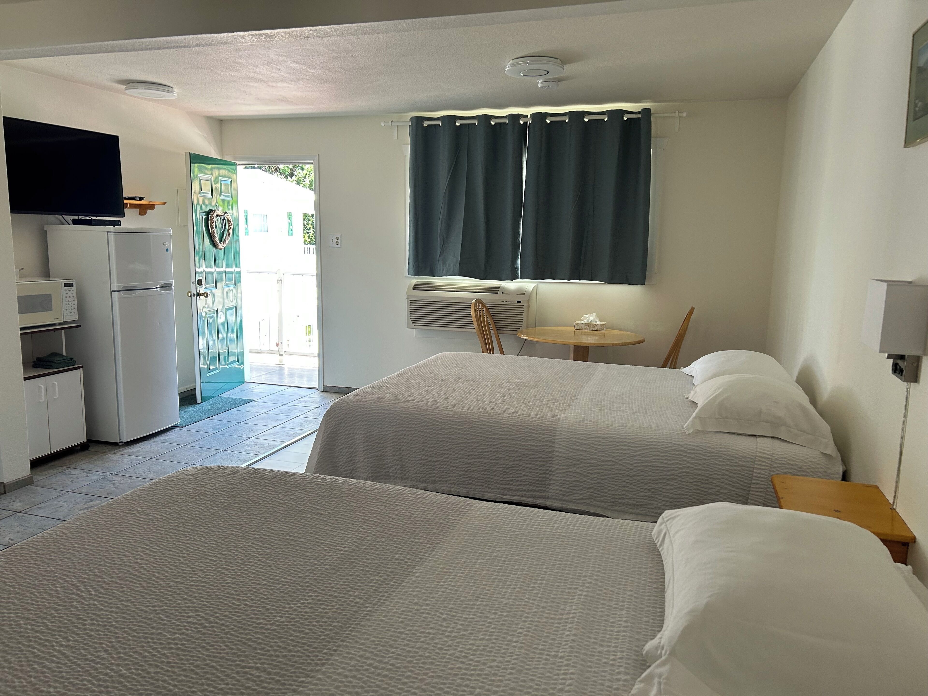 Standard Room, 2 Queen Beds | Living area | 32-inch TV with cable channels