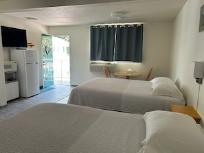 Standard Room, 2 Queen Beds | Living area | 32-inch TV with cable channels