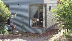 A single-story house with a large window and a birdhouse.