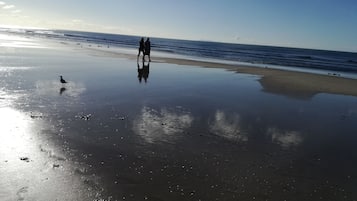 Beach nearby, white sand, beach towels