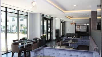 A modern interior with a seating area, tables, and a fireplace.