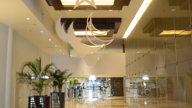 A spacious, modern lobby with a polished floor, star-shaped ceiling decorations, and a glass wall on one side. - New Town Suites at Bandar Sunway (Petaling Jaya)