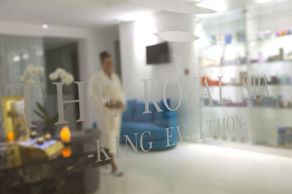 A modern interior with a glass partition displaying the text "THE ROYALS - KING ELLINGTON".