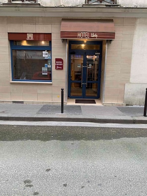A hotel named 'HOTEL LIBERTY Paris' with a closed shutter and a sign indicating WiFi availability. - Liberty (Paris)
