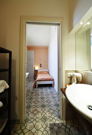 Twin kamer | Badkamer | Een douche, een haardroger, een bidet, handdoeken