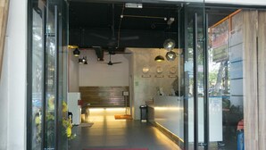 A hotel reception area with a reception desk, a clock, and a red welcome mat. - New Town Hotel Sunway Metro, Bandar Sunway (Petaling Jaya)