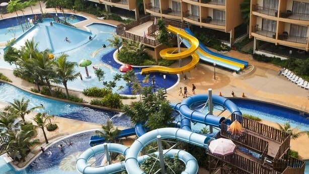 A resort with multiple swimming pools, water slides, and a covered area with lounge chairs. - New Town Hotel Sunway Metro, Bandar Sunway (Petaling Jaya)