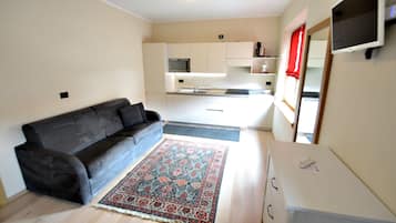 Apartment, 1 Bedroom | Living area | Flat-screen TV, heated floors
