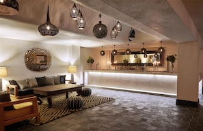 A modern living area with a sofa, coffee table, and decorative lamps.