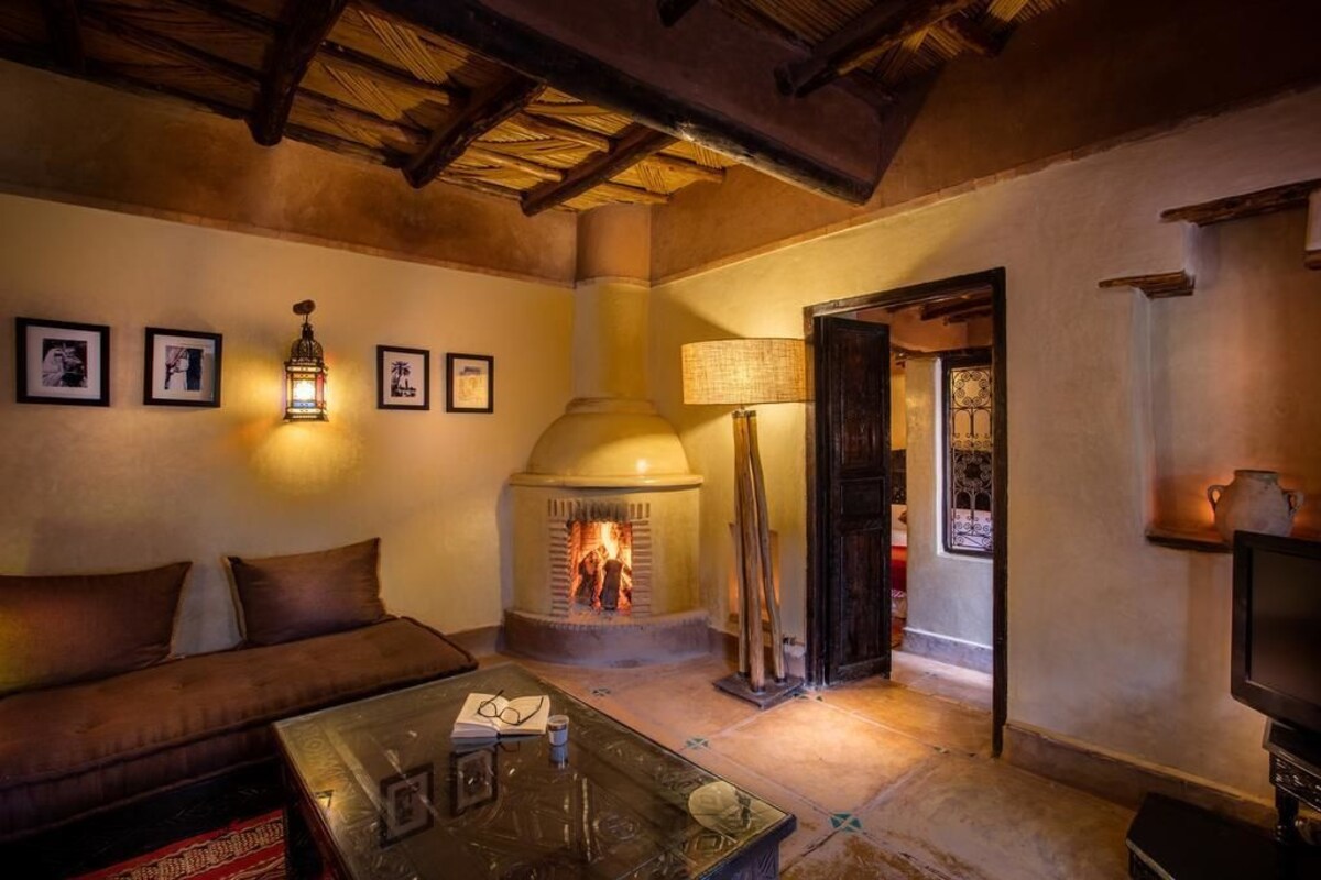 A cozy living room with a fireplace, a sofa, and a coffee table.