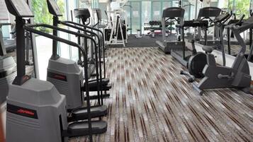A gym with treadmills, ellipticals, and weight machines.