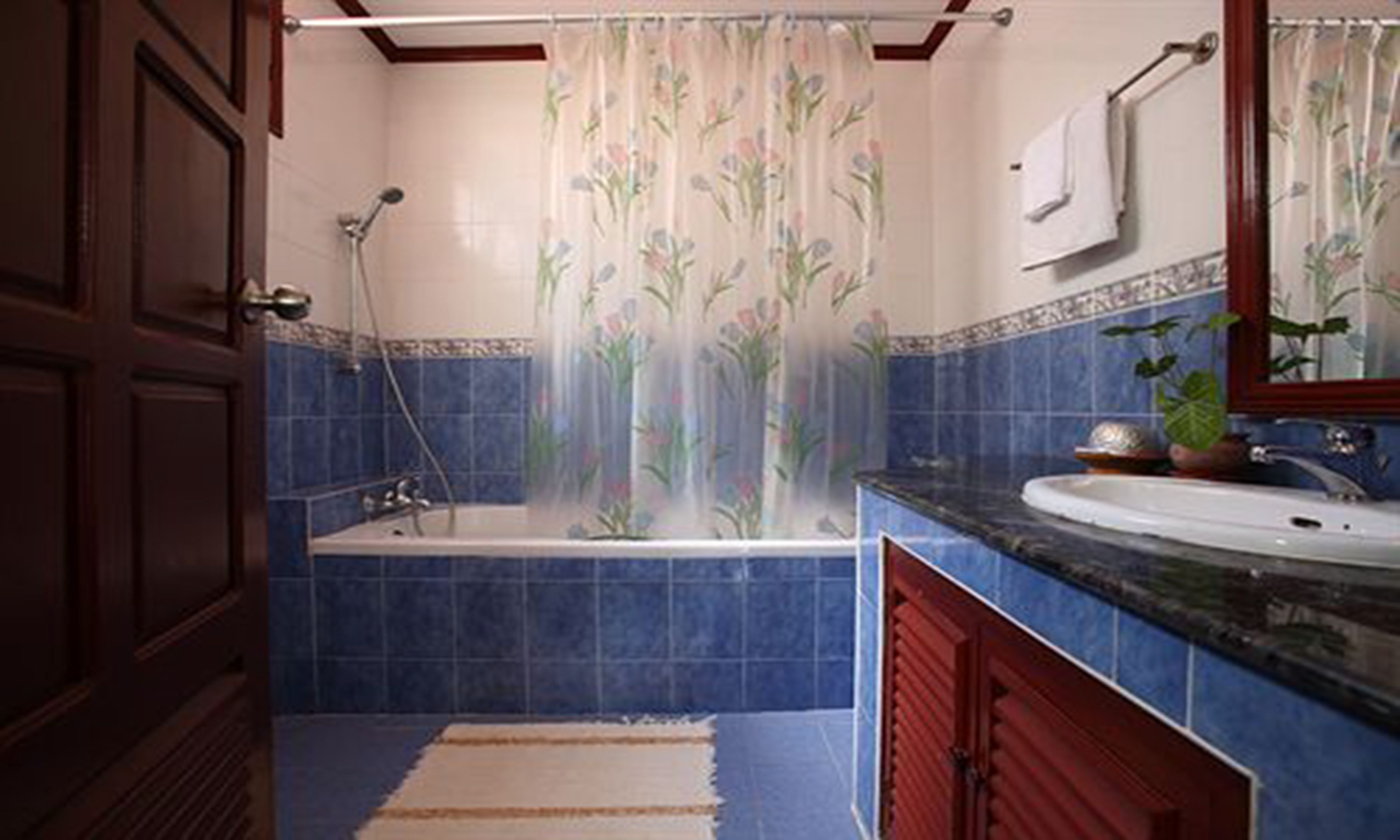 A bathroom with a bathtub, a sink, and a shower.