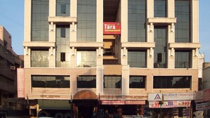 A multi-story building with a sign for "Tara International Hotel" on the second floor. - Hotel TARA International (Hyderabad)