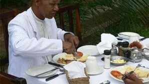 A dining table with plates, utensils, and a basket. - Pamusha Lodge (Victoria Falls)