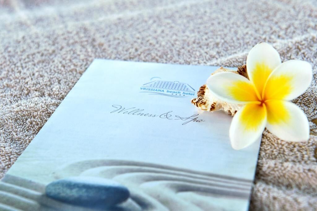 A brochure for VRISSIANA beach hotel with a wellness & spa section.