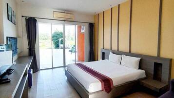 A modern hotel room with a large bed, a desk, and a view of the outdoors.