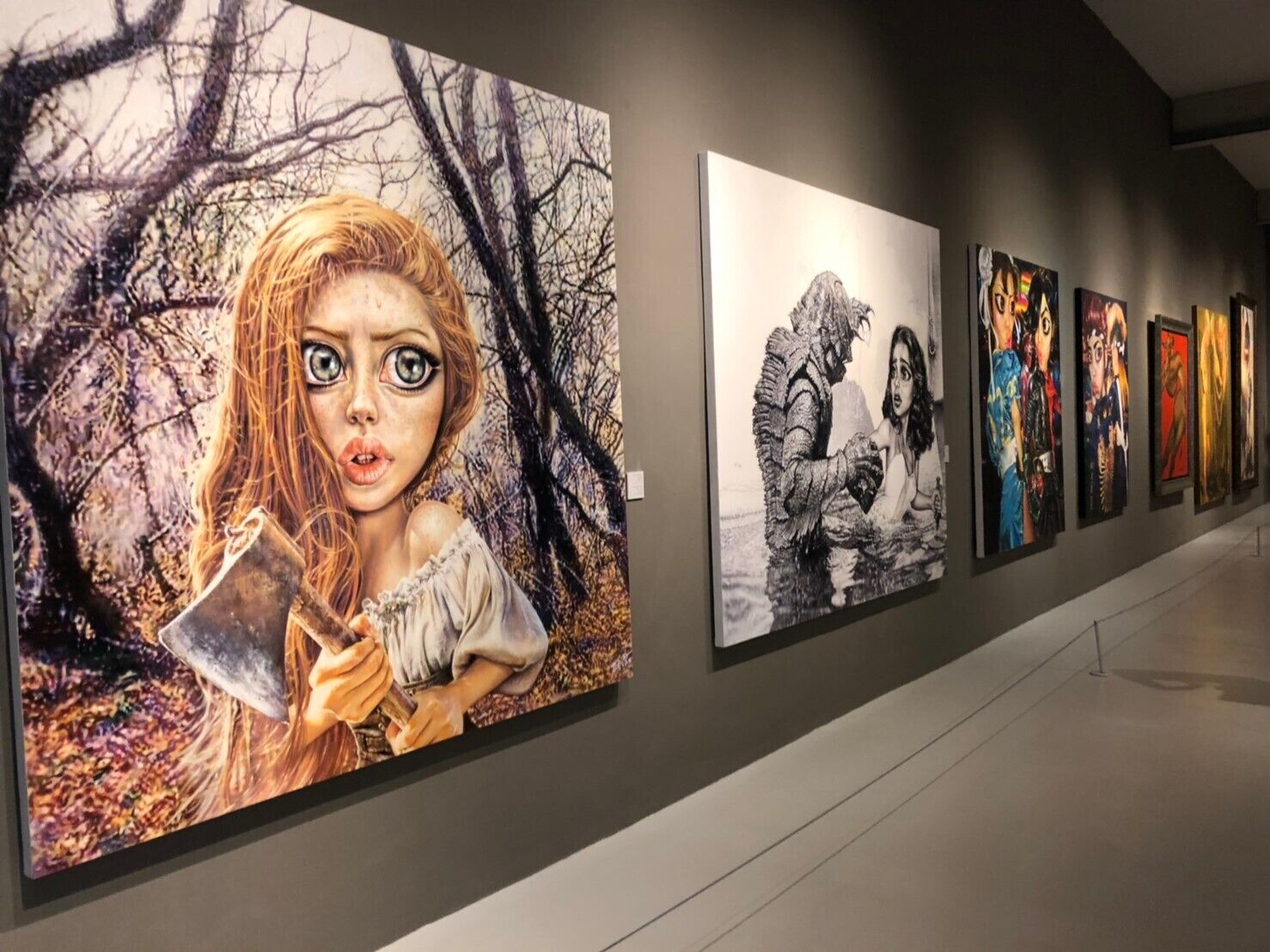 A gallery with various artworks displayed on the walls.