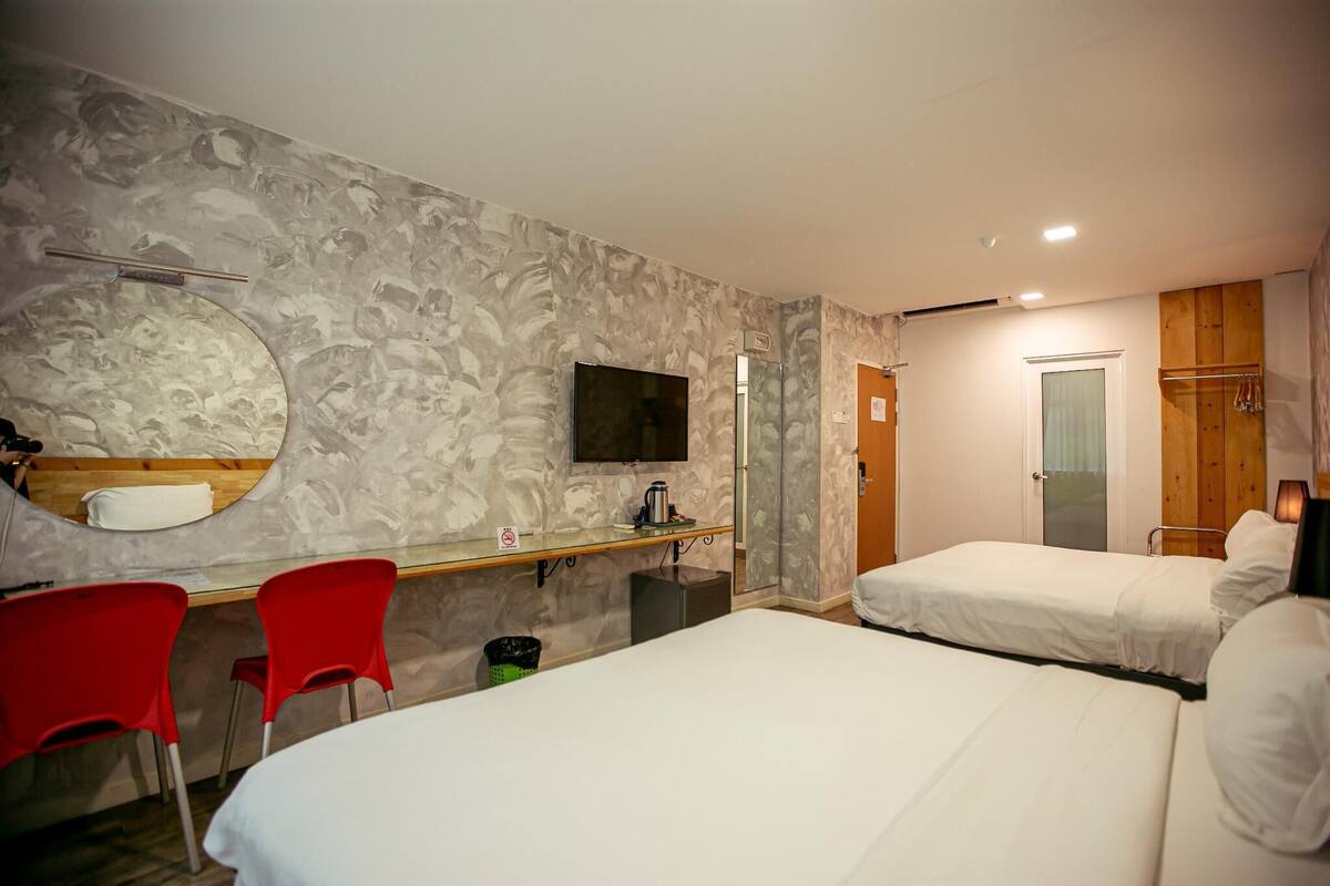 deluxe quad | in-room safe, desk, blackout curtains, rollaway beds