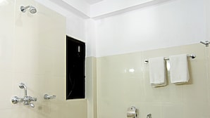 A bathroom with a toilet, a shower, and a sink. - Thamel Grand Hotel (Kathmandu)