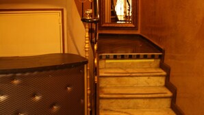 A staircase with a wooden handrail and a metal railing, leading to a door at the top. - Arcotel (Cannes)