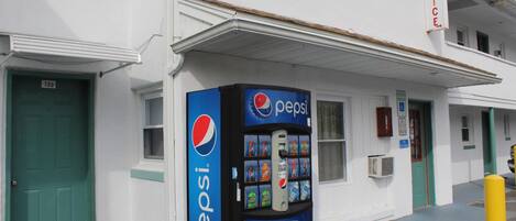 Un edificio con una máquina expendedora de Pepsi afuera.